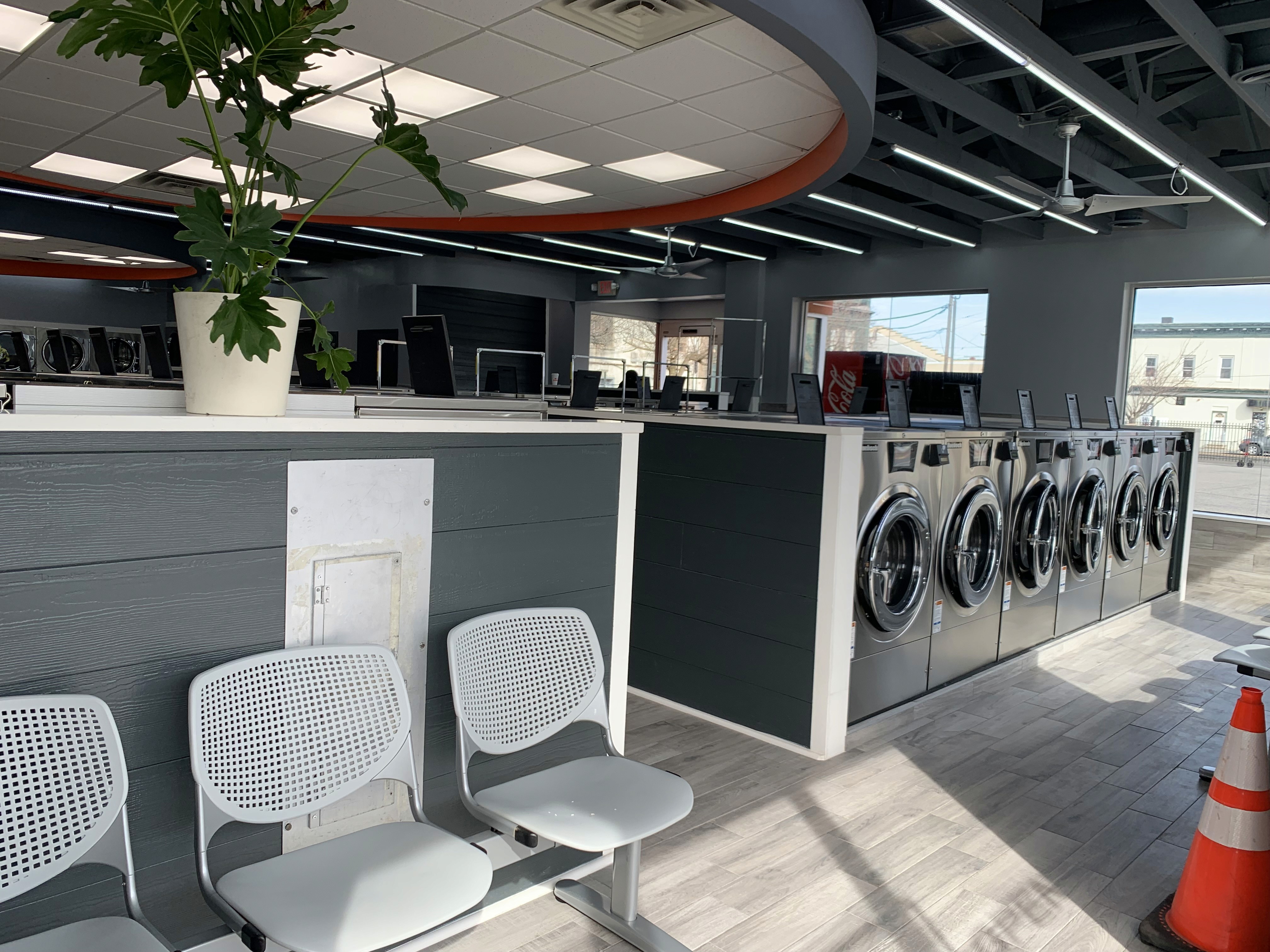 Seating and washers inside Razzle Dazzle Laundromat